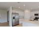 Modern kitchen with stainless steel appliances, white cabinetry, and island with breakfast bar at 5025 Bougainvillea Ct, Lake Hamilton, FL 33851