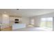 Open living area connecting the kitchen and dining, filled with natural light from a large sliding door at 5025 Bougainvillea Ct, Lake Hamilton, FL 33851