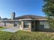 Spacious backyard featuring a concrete patio, verdant lawn, and neutral paint scheme at 524 Buckshot Ln, Lakeland, FL 33809