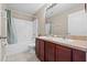 Bathroom with double sinks, vanity with cabinets, tub and shower combo with curtain at 524 Buckshot Ln, Lakeland, FL 33809