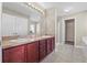 Bathroom featuring dual sinks, vanity with drawers and cabinets, tiled floor and walk-in shower at 524 Buckshot Ln, Lakeland, FL 33809