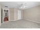 Neutral bedroom with carpet flooring and entry to hallway with hard wood flooring at 524 Buckshot Ln, Lakeland, FL 33809