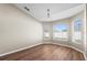 Bright bedroom with wood-look floors, fresh paint, and natural light streaming through large windows at 524 Buckshot Ln, Lakeland, FL 33809