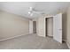 Bedroom showcasing neutral walls, carpet flooring, ceiling fan and closet at 524 Buckshot Ln, Lakeland, FL 33809