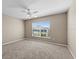 Large bedroom with neutral carpet, ceiling fan, and a view from the window at 524 Buckshot Ln, Lakeland, FL 33809