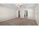 Carpeted bedroom showcasing an open doorway to the hallway and closet at 524 Buckshot Ln, Lakeland, FL 33809