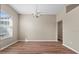 Dining room featuring wood-look flooring, a chandelier, a large window, and fresh, neutral paint throughout at 524 Buckshot Ln, Lakeland, FL 33809