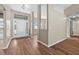 Inviting foyer with wood-look floors, a stylish light fixture, neutral paint, and an elegant front door at 524 Buckshot Ln, Lakeland, FL 33809