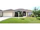 Charming single-story home with a well-manicured lawn, mature trees, and a two-car garage at 524 Buckshot Ln, Lakeland, FL 33809