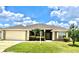 Charming single-story home with a manicured lawn, freshly painted exterior, and attached two car garage at 524 Buckshot Ln, Lakeland, FL 33809