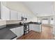 Modern kitchen showcasing stainless steel appliances, white cabinets, and wood-look flooring at 524 Buckshot Ln, Lakeland, FL 33809