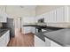 Modern kitchen featuring white cabinets, stainless steel appliances, and sleek countertops at 524 Buckshot Ln, Lakeland, FL 33809