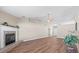 Bright living room featuring a fireplace, wood-look flooring, neutral paint, and an open layout at 524 Buckshot Ln, Lakeland, FL 33809