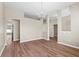 Spacious living room featuring wood-look flooring, a modern chandelier, and fresh, neutral paint throughout at 524 Buckshot Ln, Lakeland, FL 33809