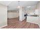 Open-concept living area with wood floors, neutral walls, and modern lighting fixtures at 524 Buckshot Ln, Lakeland, FL 33809