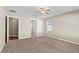 Large bedroom features ceiling fan, carpet flooring and doorways to bathroom and closet at 524 Buckshot Ln, Lakeland, FL 33809