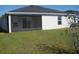 Featuring a screened lanai and a simple backyard, providing privacy and comfort at 1371 Pompay Dr, Davenport, FL 33896
