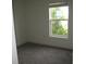 A modest-sized carpeted bedroom features a bright window with natural light at 1371 Pompay Dr, Davenport, FL 33896