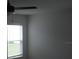 A sunlit room with a ceiling fan and large windows at 1371 Pompay Dr, Davenport, FL 33896