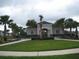 Community clubhouse featuring landscaped grounds, benches, and gated entry, perfect for gatherings at 1371 Pompay Dr, Davenport, FL 33896