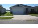 Charming one-story home featuring a two car garage, well-maintained lawn, and traditional design at 1371 Pompay Dr, Davenport, FL 33896