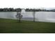 Backyard view of a pond with fountain feature and community landscaping at 1371 Pompay Dr, Davenport, FL 33896