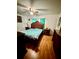 Bedroom with ceiling fan and turquoise curtains at 2480 Brownwood Dr, Mulberry, FL 33860