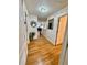 Hallway with gleaming hardwood floors, neutral walls, and a view into other rooms of the house at 2480 Brownwood Dr, Mulberry, FL 33860