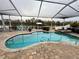 Beautiful pool area with a view of the lake, comfortable seating, and lush landscaping at 2480 Brownwood Dr, Mulberry, FL 33860