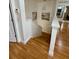 Staircase with hardwood steps and white railings, illuminated by modern lighting fixtures at 2480 Brownwood Dr, Mulberry, FL 33860