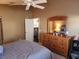 Bedroom with a ceiling fan and a wooden dresser with a mirror at 2523 Mariel Way, The Villages, FL 32162