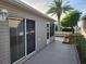 Exterior view of a house with an enclosed lanai and a patio, showing the home's clean design at 2523 Mariel Way, The Villages, FL 32162