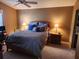 Cozy main bedroom with a ceiling fan, side tables, and lamps for a warm ambiance at 2523 Mariel Way, The Villages, FL 32162