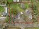 Aerial view of the property showcasing the home, buildings and lot size, surrounded by mature trees at 820 N Carroll Rd, Lakeland, FL 33801