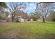 Aerial view of a single story home with an open backyard, lawn, and mature trees at 820 N Carroll Rd, Lakeland, FL 33801