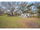 RV on a lot with mature trees and a well-maintained yard, creating a peaceful setting with room to roam at 820 N Carroll Rd, Lakeland, FL 33801