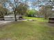 Aerial view of a single story home with an open backyard, lawn, and mature trees at 820 N Carroll Rd, Lakeland, FL 33801