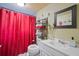 Cozy bathroom with a red curtain and a white vanity at 820 N Carroll Rd, Lakeland, FL 33801