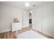 Bedroom featuring a bed, wood-look flooring, modern light fixture, and a window with view to the outdoors at 820 N Carroll Rd, Lakeland, FL 33801