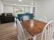 Open-concept dining area featuring a wooden table, white chairs, and a view into the living room at 820 N Carroll Rd, Lakeland, FL 33801