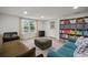 Inviting living room featuring a large window, comfortable seating, and built-in shelving for storage at 820 N Carroll Rd, Lakeland, FL 33801