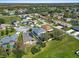 Aerial view showcases a home with screened pool, solar panels and a trampoline nestled in a residential neighborhood with small lakes at 913 Parasol Pl, Kissimmee, FL 34759