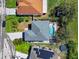 Aerial view of a home with a screened pool and solar panels in a residential neighborhood with mature trees and landscaping at 913 Parasol Pl, Kissimmee, FL 34759