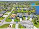 The property from an aerial view showcasing the neighborhood's layout near a scenic blue lake at 913 Parasol Pl, Kissimmee, FL 34759