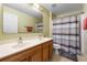 Bathroom featuring dual sinks, a spacious vanity, and a shower tub combination at 913 Parasol Pl, Kissimmee, FL 34759