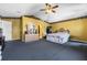 Spacious bedroom with decorative accents, a ceiling fan, and an en suite bathroom at 913 Parasol Pl, Kissimmee, FL 34759