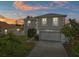 Charming two-story home with a well-maintained lawn during the sunset at 913 Parasol Pl, Kissimmee, FL 34759