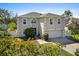 Charming two-story home with a large front yard, manicured landscaping, two-car garage and neutral color scheme at 913 Parasol Pl, Kissimmee, FL 34759