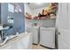 Efficient laundry room features modern washer and dryer with wire shelving for organized storage at 913 Parasol Pl, Kissimmee, FL 34759