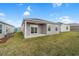 Relaxing backyard featuring a covered patio perfect for outdoor entertaining and a well-maintained lawn at 1974 Lockett Ln, The Villages, FL 34762
